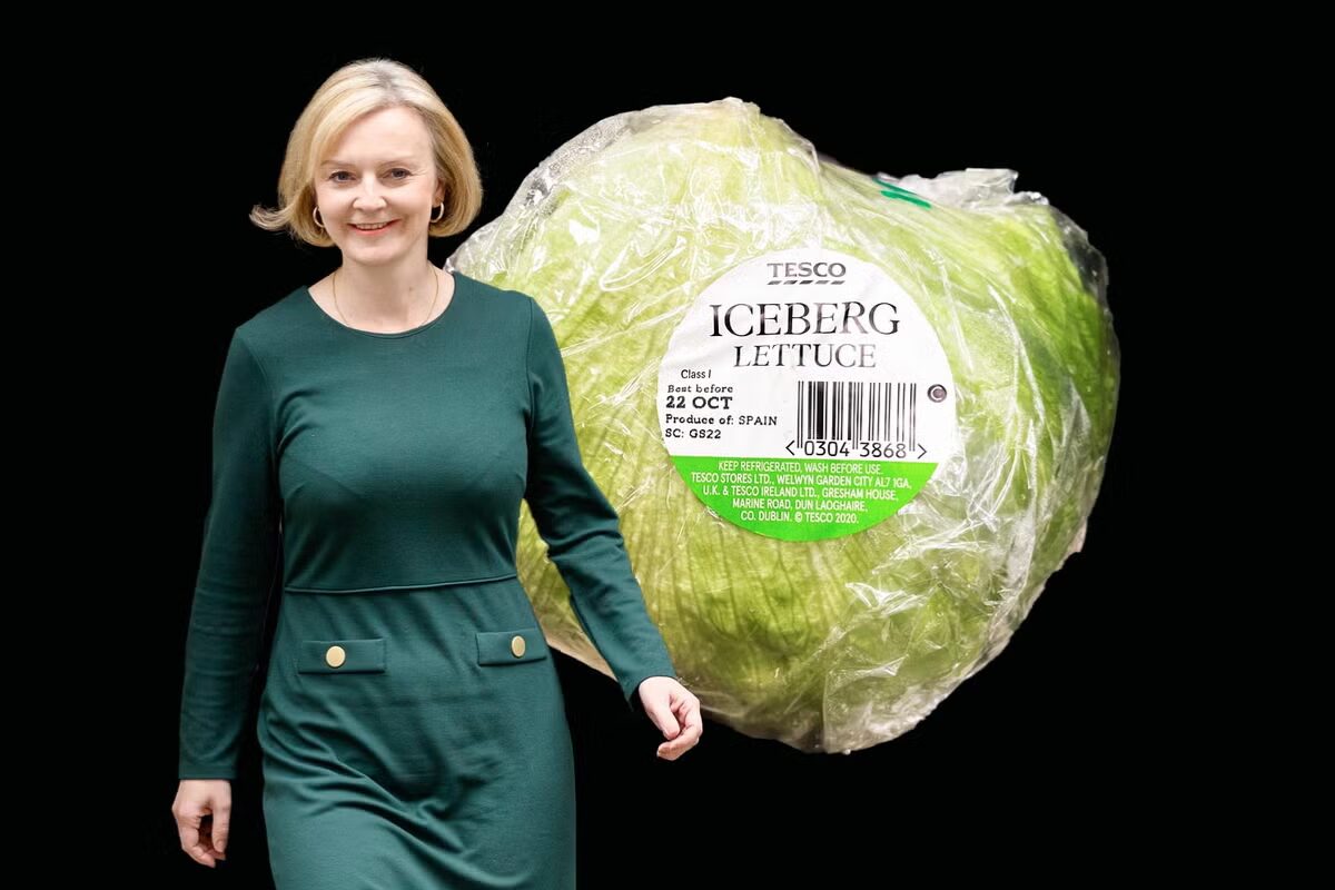 A photo illustration of former UK Prime Minister Liz Truss walking alongside a large head of Tesco Iceberg lettuce with the text "Best before 22 OCT" visible on the packaging.
