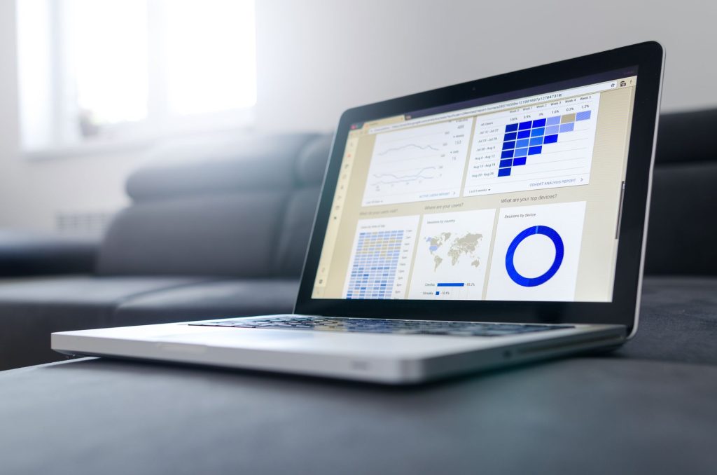 A close-up of a laptop displaying a modern CRM dashboard with real-time marketing attribution analytics