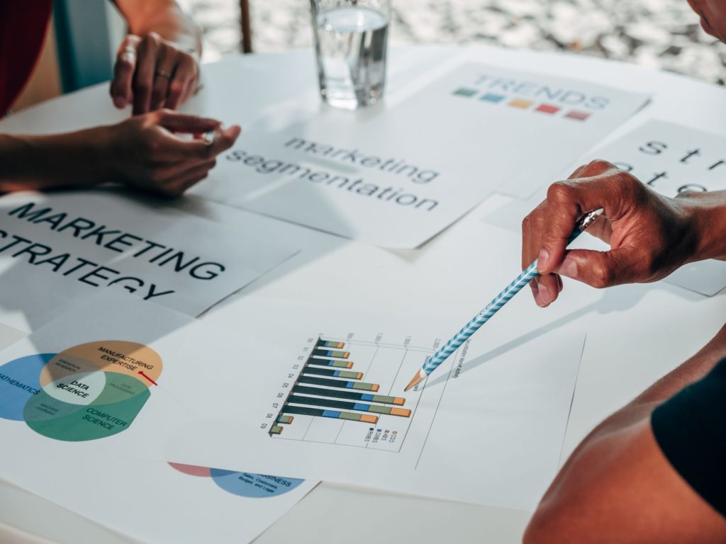 Business team collaborating on competitive marketing analysis in a modern office