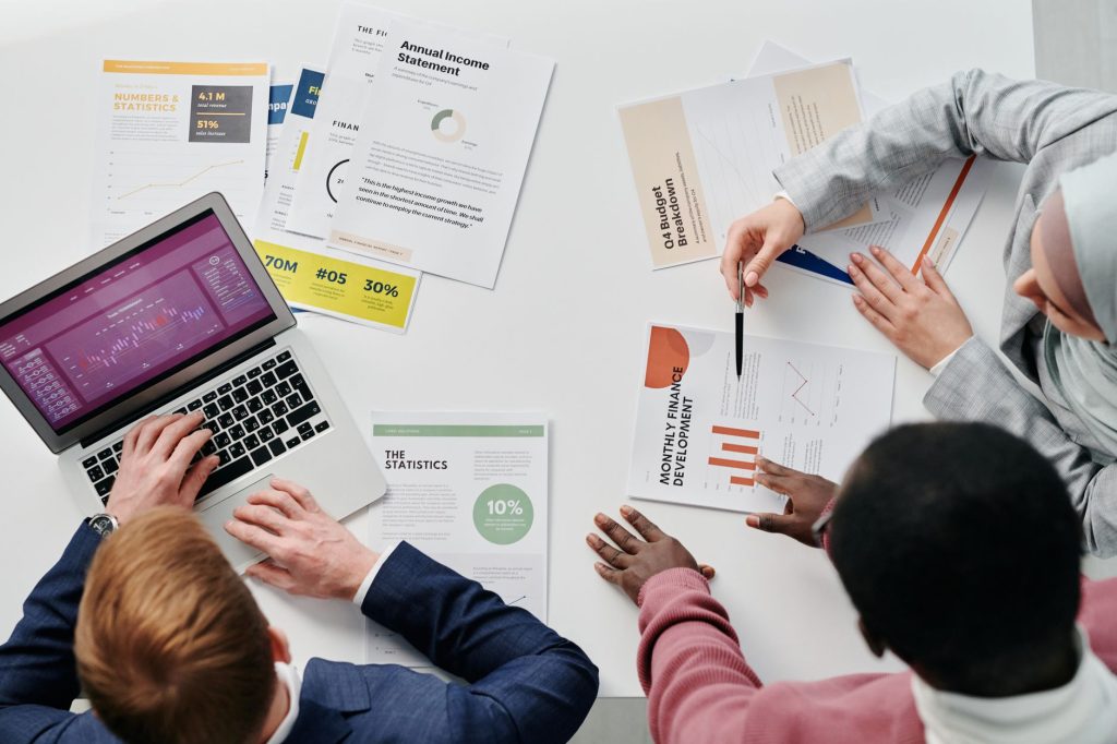 Marketing and sales professionals reviewing pipeline progression metrics on a screen