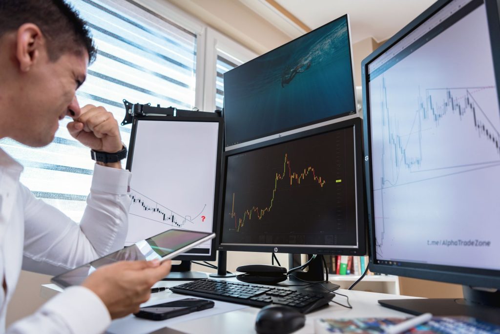 Analyst examining conflicting data silos and vanity metrics on office displays