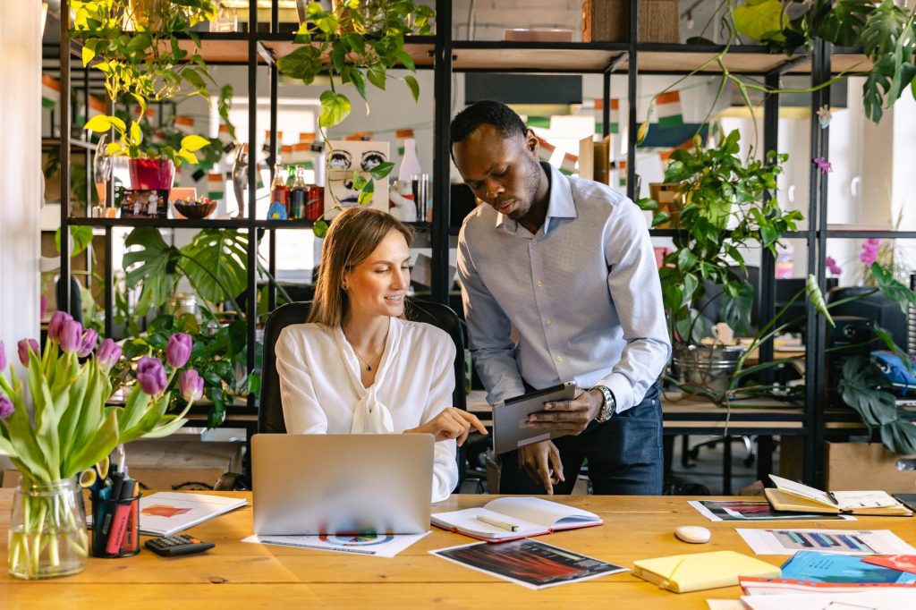 Sales representative and marketing manager checking real-time campaign engagement metrics