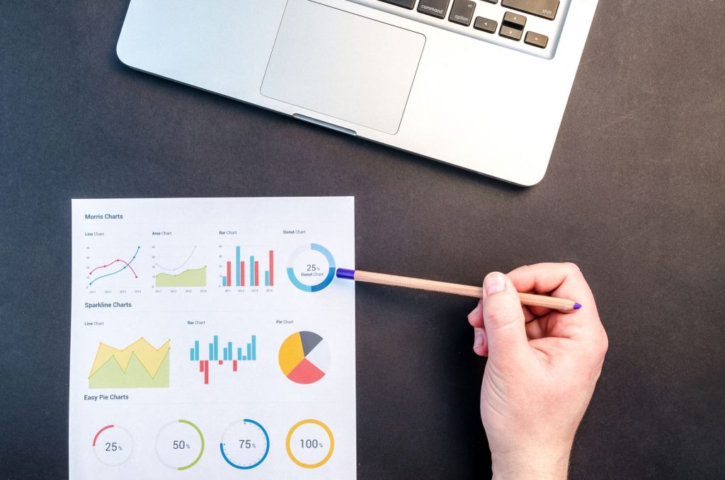 Marketing analyst evaluating pipeline metrics and acquisition costs on a laptop