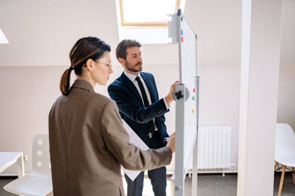 Marketing and sales managers analyzing buyer journey stages and conversion gates