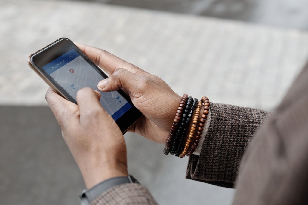 A person checking business directory listings and map locations on a mobile phone
