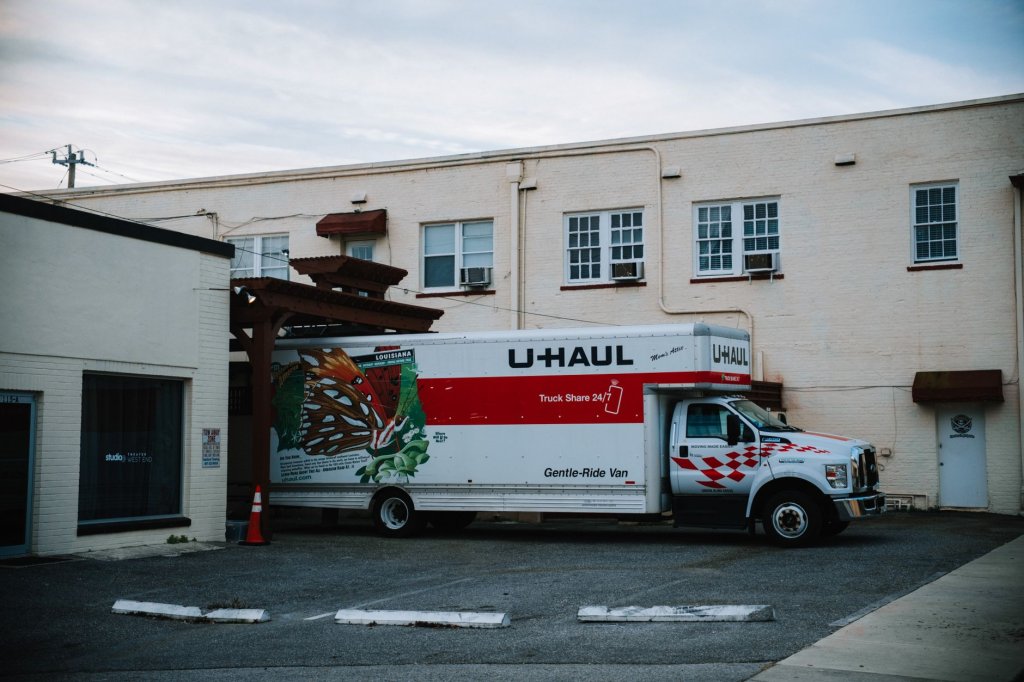 A clean, professional branded moving truck on a residential street