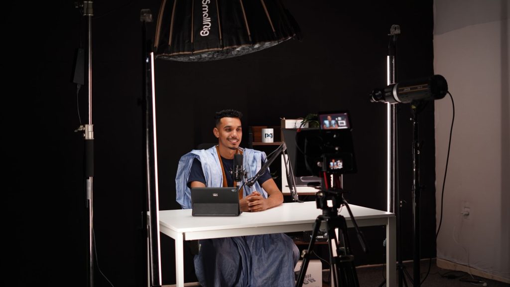 A professional recording technical video content for YouTube in a studio setup