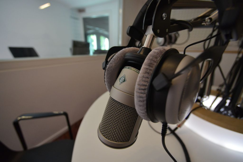 A professional podcasting setup with a high-quality microphone and headphones in a studio