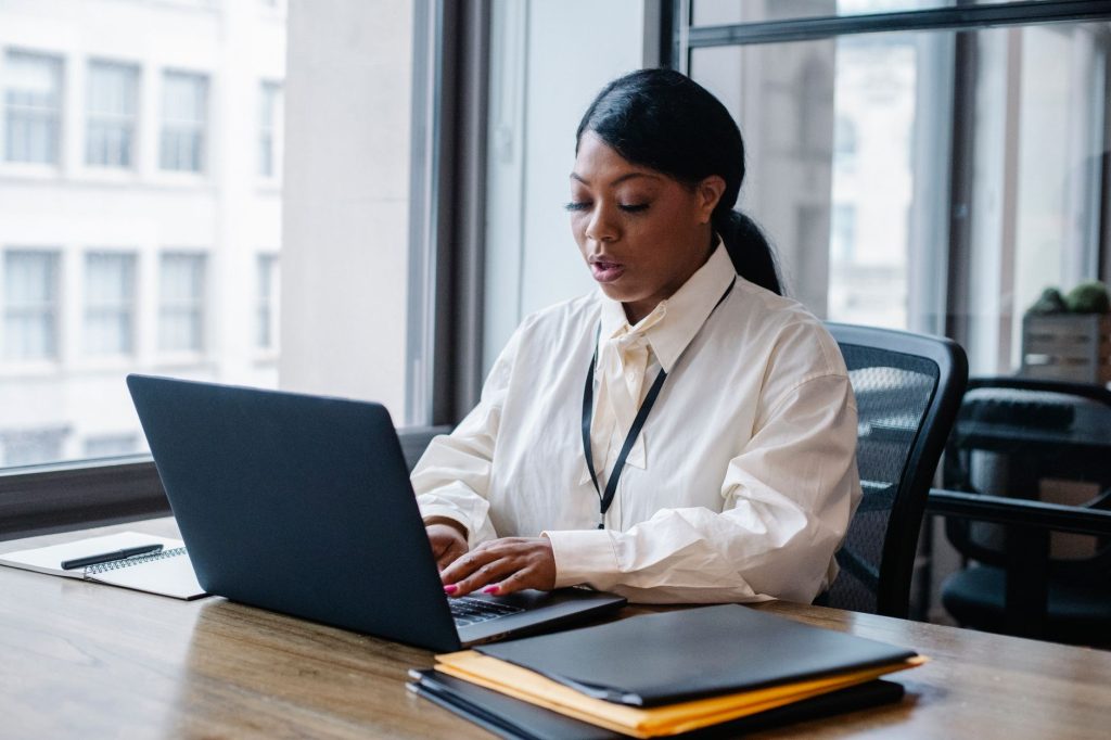 Professional networking and sharing company insights on a laptop in an office