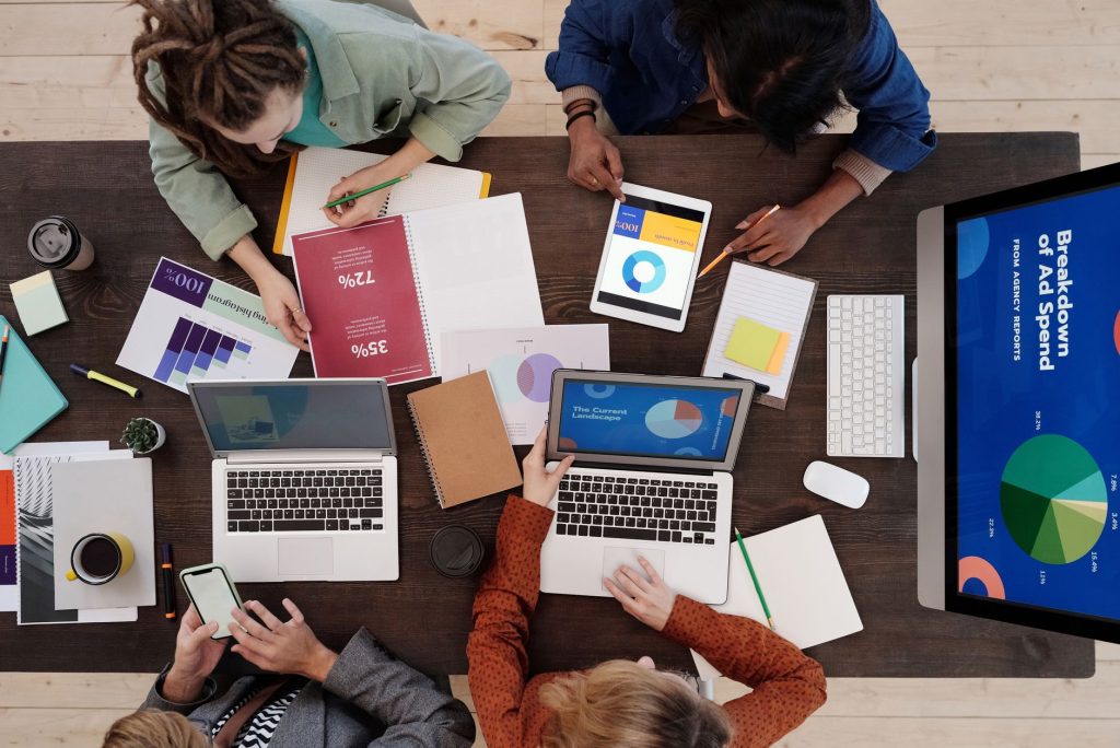 Growing marketing team reviewing multi-channel campaign analytics together