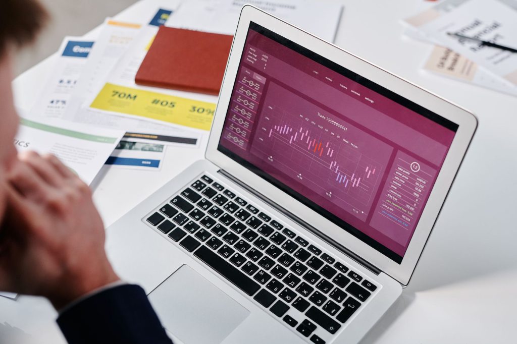 Marketer evaluating platform pricing tiers and licensing models on a laptop