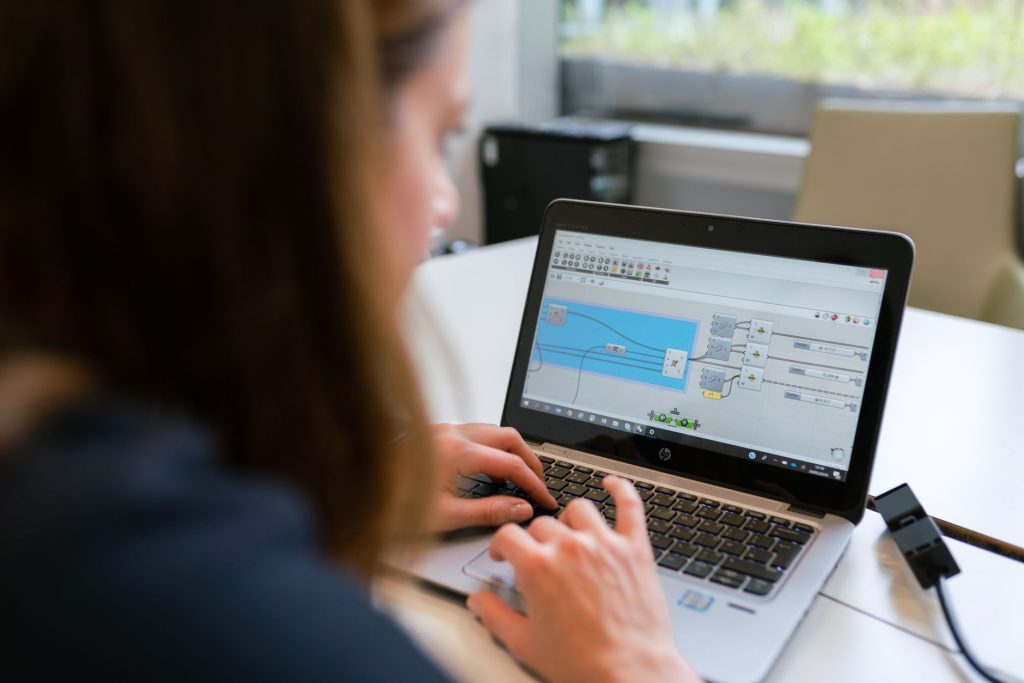 Marketing specialist testing connected social media accounts on a laptop
