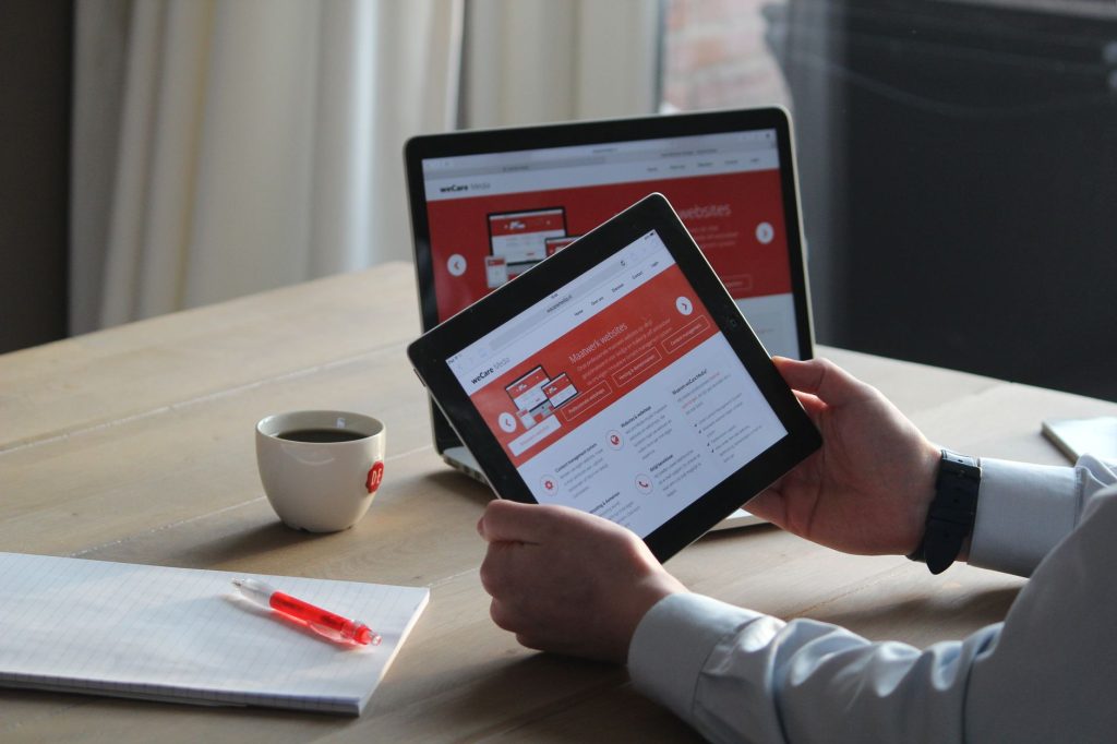 Content creator organizing multi-slide carousel graphics on a tablet