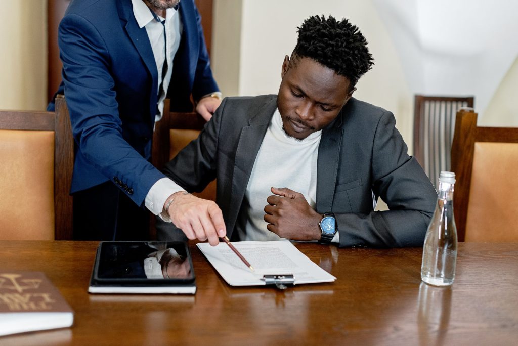 Attorney using a digital tablet in a law library to select practice area marketing platforms