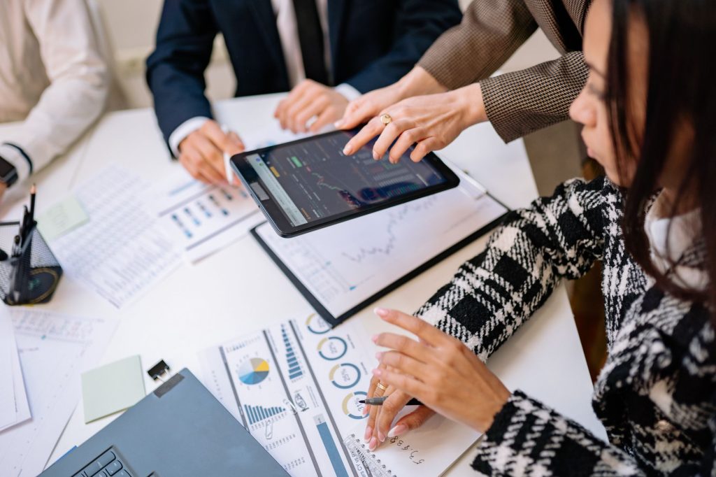 Law firm management team evaluating digital analytics and client intake conversion charts