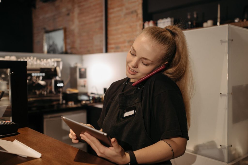Restaurant manager checking digital reservations and table bookings on a tablet