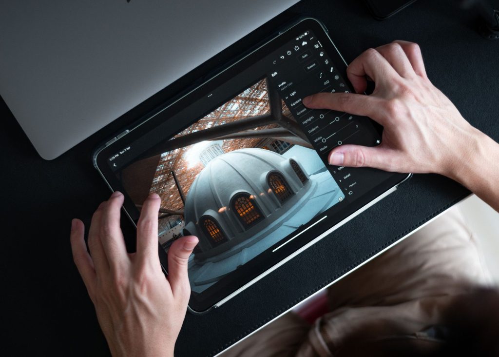 Digital creator editing multi-channel visual assets and graphics on a tablet
