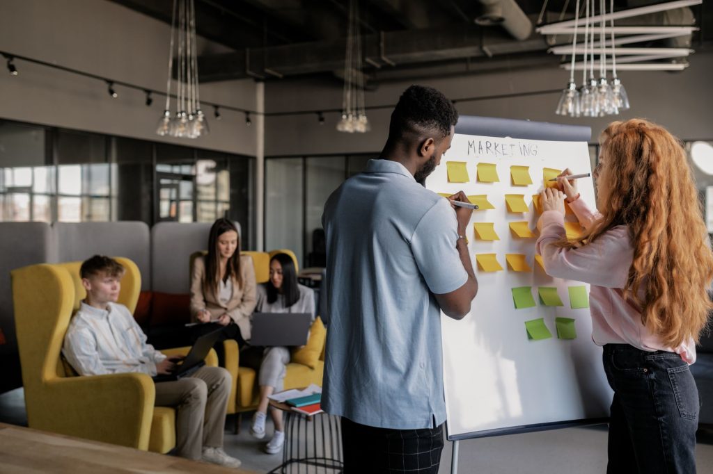 Marketing team collaborating over creative editorial drafts in a modern studio