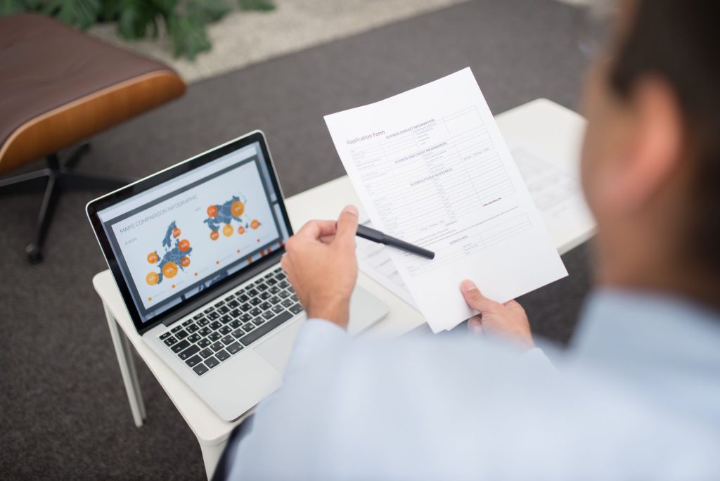 Editor analyzing long-form document drafts on an office monitor
