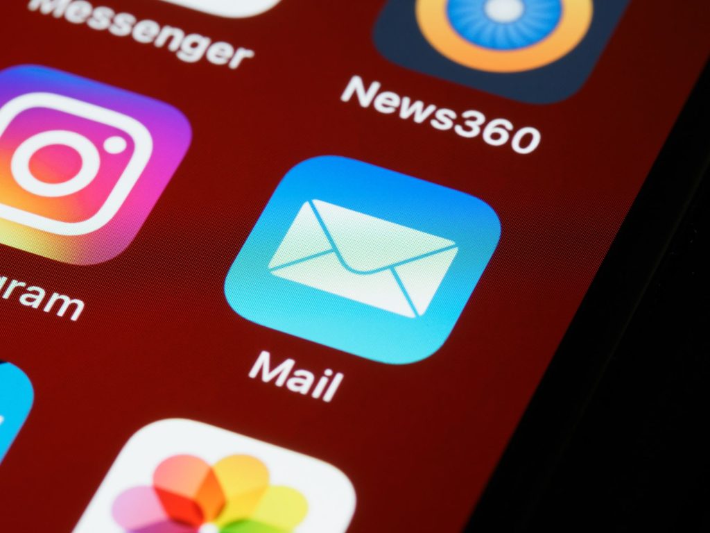 A person using a phone to move between email, messaging, an app, and social media.