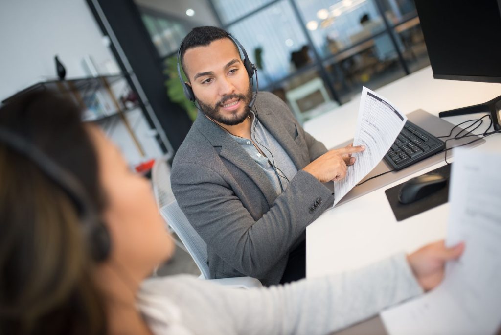 A moderator checks customer content on a screen.
